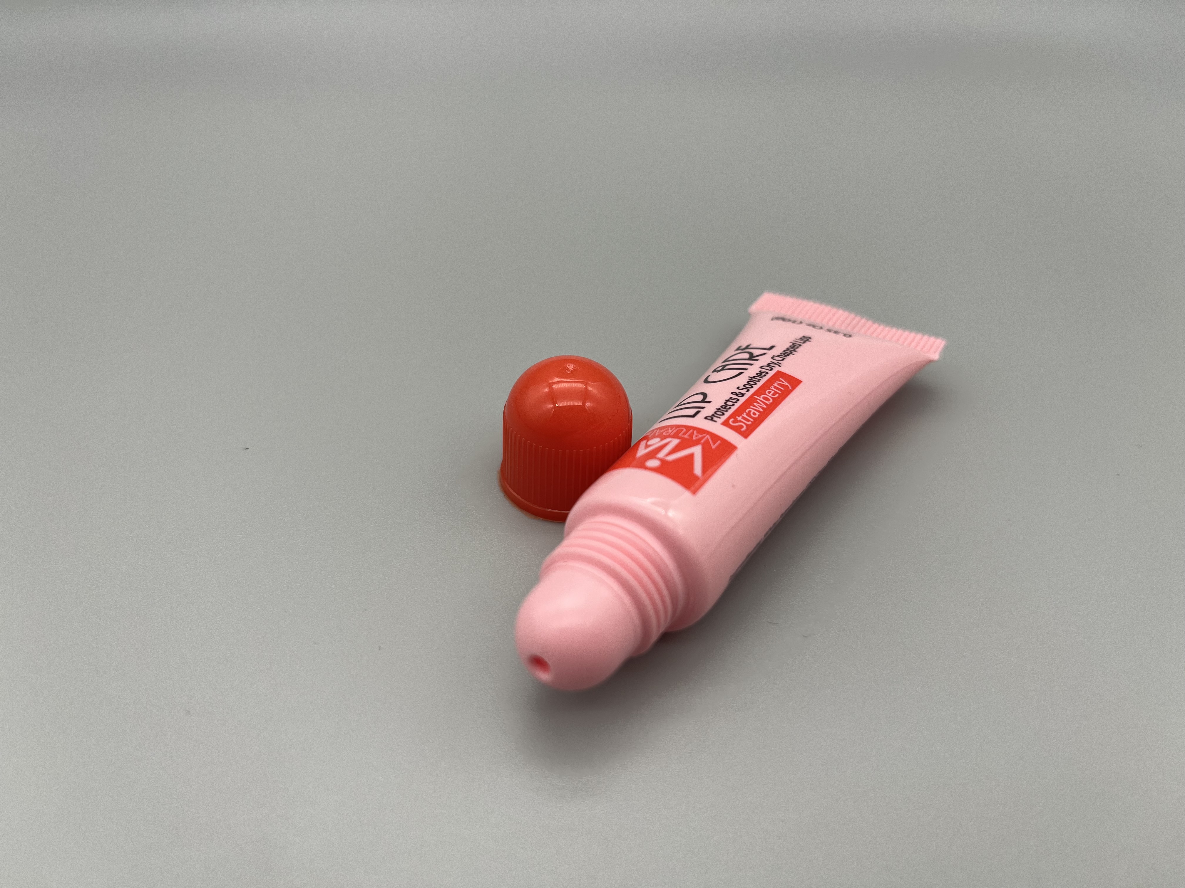 red round lip balm tube