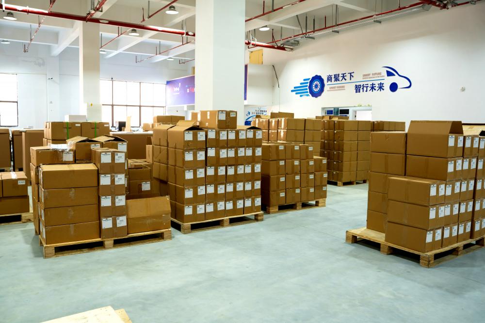 Large Warehouse with Cardboard Boxes and Corporate Slogan