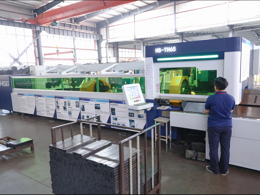 Worker Operating HS-TH65 CNC Machine in Factory