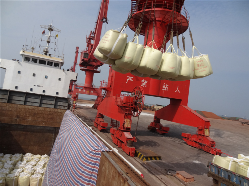 Road salt in jumbo bags  are being loaded  in a ship to Japan