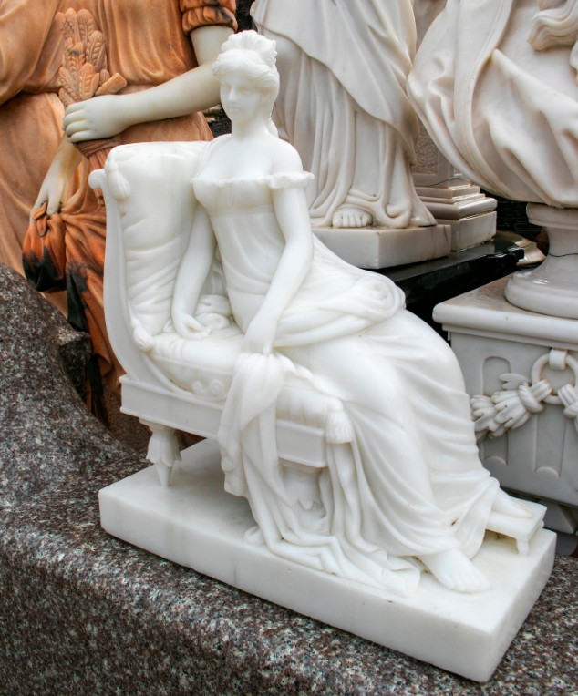 Elegant Lady Resting on Marble Couch Sculpture