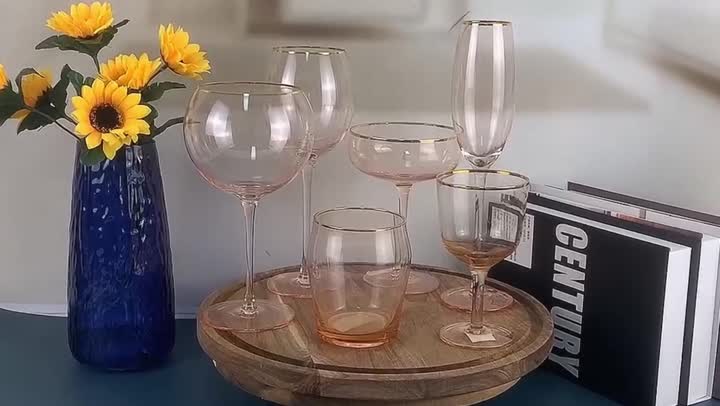 pink colored wine glass set with gold rim