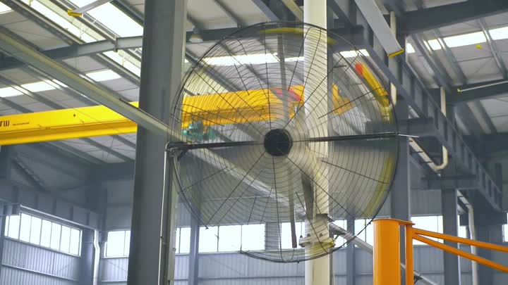 Rotating wall fan in workshop