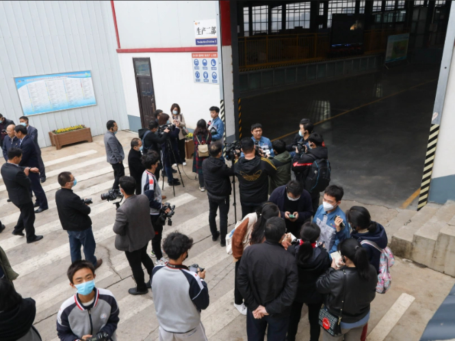 Media Gathering at Factory for Coverage