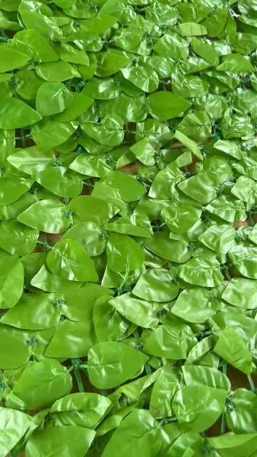 Display the artificial green plant splicing base plate with light-colored peach leaves