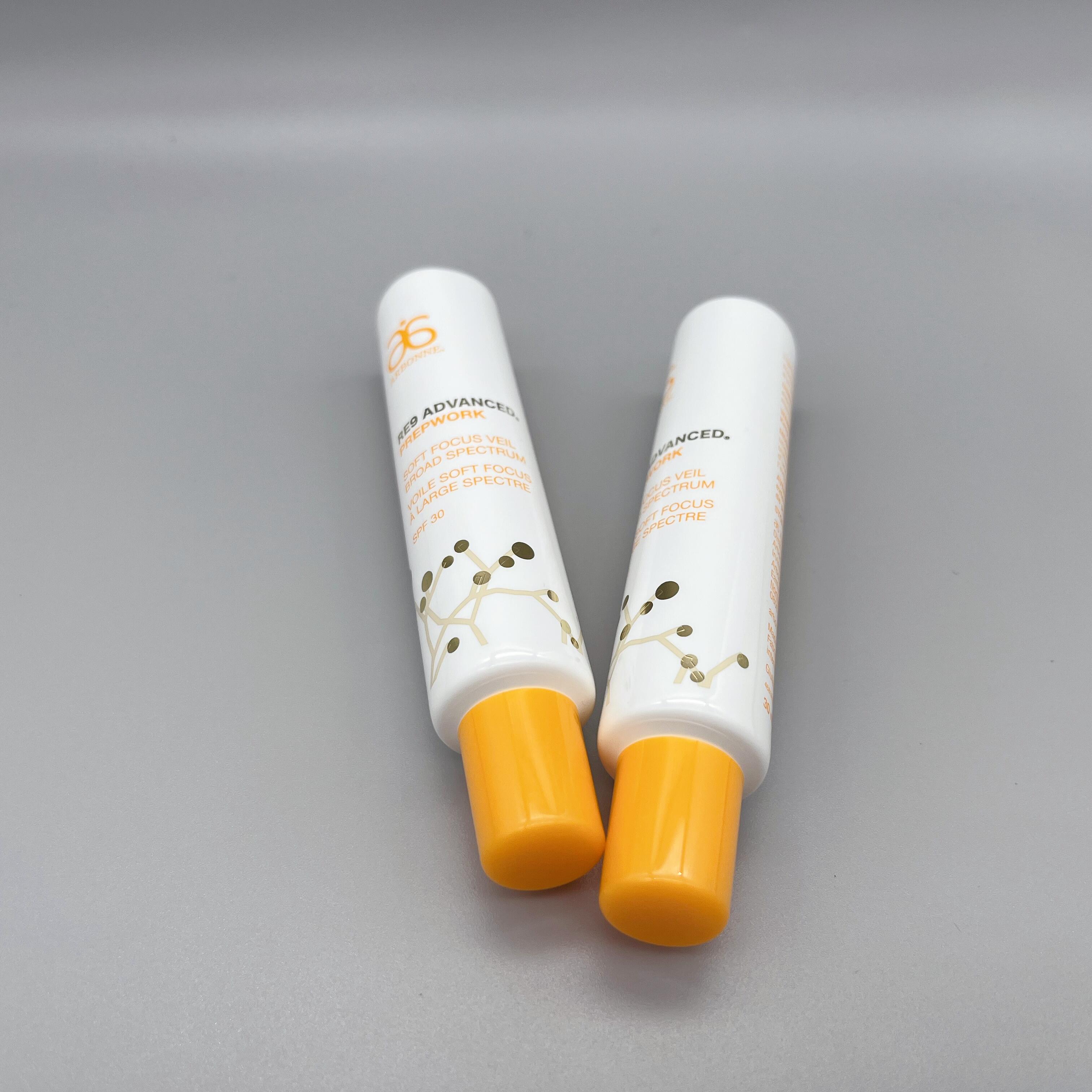 orange and white long nozzle essence tube