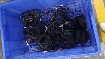 Workers use an injection molding machine to injection mold cable ends