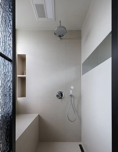 Luxury hotel bathroom featuring brass shower system installation