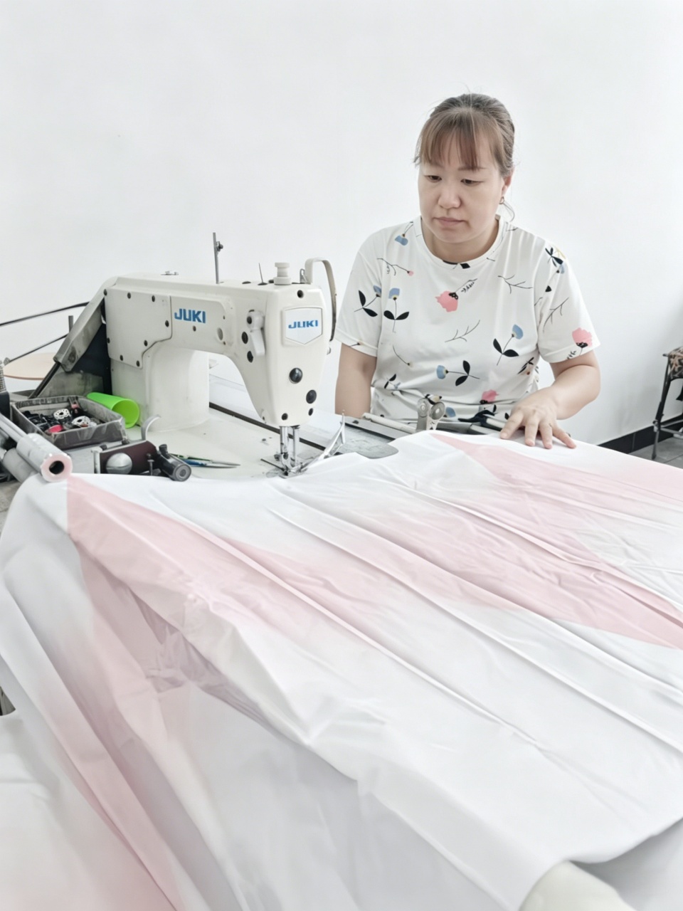Worker-doing-overlocking-on-edge-binding-machine-umbrella-fabric