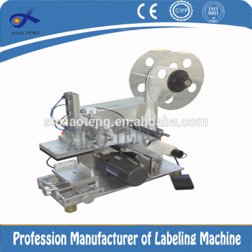Semi-automatic small cap labeling machine