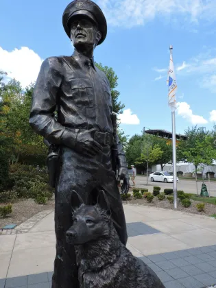 Outdoor garden life size bronze police man and police dog statue