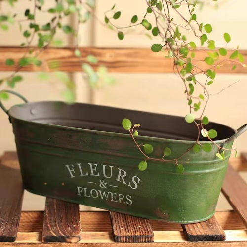 Retro made old iron flower arrangement bucket