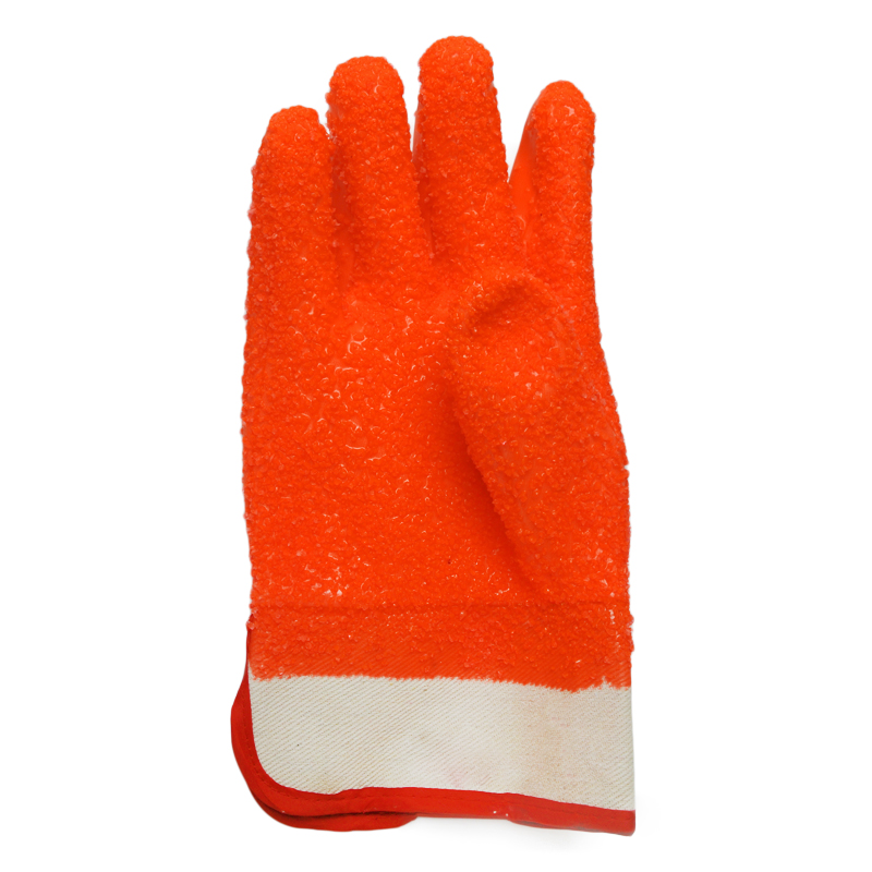 Fluoreszierender orangefarbener PVC-Handschuh. Gummipunkte auf der Handfläche