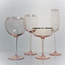 pink colored wine glass set with gold rim