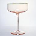 hand blown champagne saucer glass with gold rim