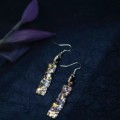 Des boucles d'oreilles conçues "Nightfall" appliquent