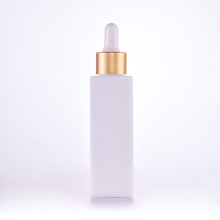 Opal white square bottle with golden dropper cap