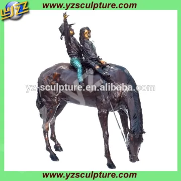 large cast bronze children riding horse statue