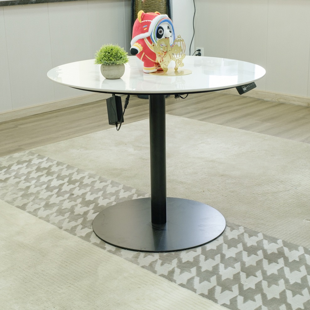 A Smart Lift Desk is a table that adjusts its height and is usually controlled by an electric or manual mechanism. It features a desktop that can stay at different heights, allowing the user to adjust the height of the desktop as needed to suit different work needs and body positions. The round Table Lifting table is suitable for people who work for long hours to use the Table Lifting Frame, which can reduce fatigue and pressure on the cervical and lumbar vertebrae and improve work efficiency and comfort Furniture.