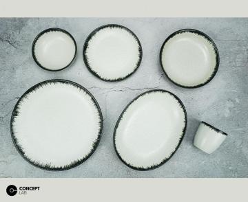 Reactive glazed stoneware dinner set with black rim