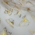 Tessuto tulle in poliestere con lamina di farfalle dorate