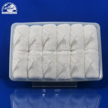 white disposable airline cotton face towel