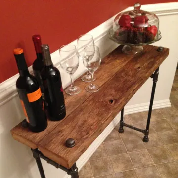 Black cast iron pipe fitting parts in DIY reclaimed table