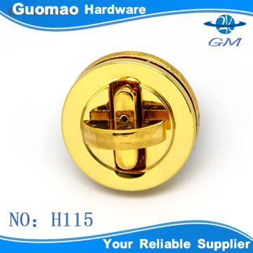 round bag lock with gold cross twist