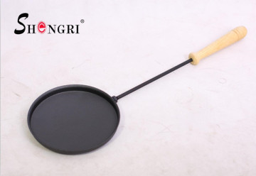 vegetable oil cast iron fry pan with wooden handle
