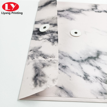 folder with marble pattern and botton string