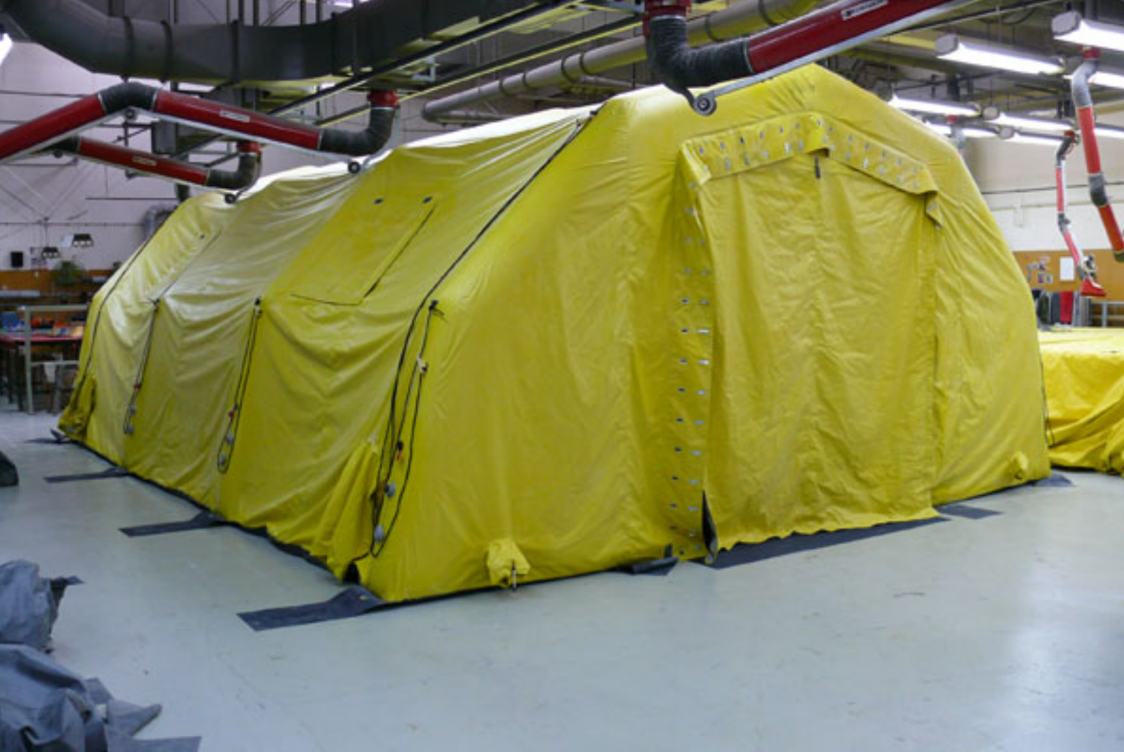Yellow inflatable rescue tent in a warehouse
