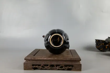 Two sets of hand holding teapot and tea set