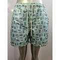 Shorts da spiaggia per icone del cartone animato verde chiaro