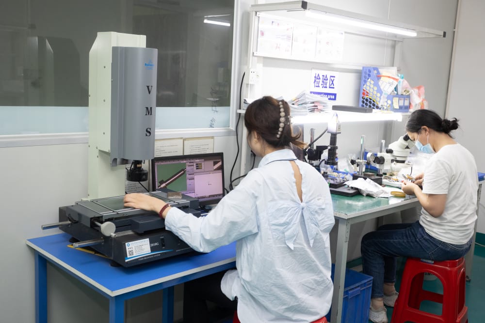 Engineers inspect Pogo Pin connectors