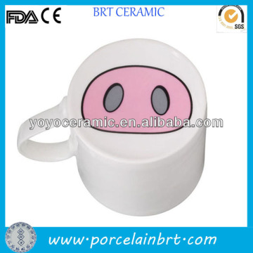 white porcelain nose mug