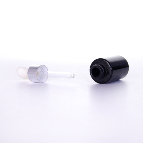 Schwarze ätherische Ölflaschen mit weißer Gummi -Glühbirne