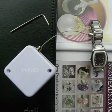 retractors and tethers for retail store displays