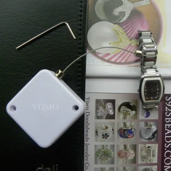 retractors and tethers for retail store displays