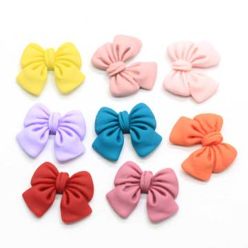 100 sztuk kolorowe Bowknot żywica rzemiosło dekoracyjne muszka wstążka Flatback Cabochon księga gości DIY ozdoby akcesoria