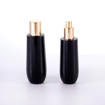 Black glass bottle with golden aluminum cap