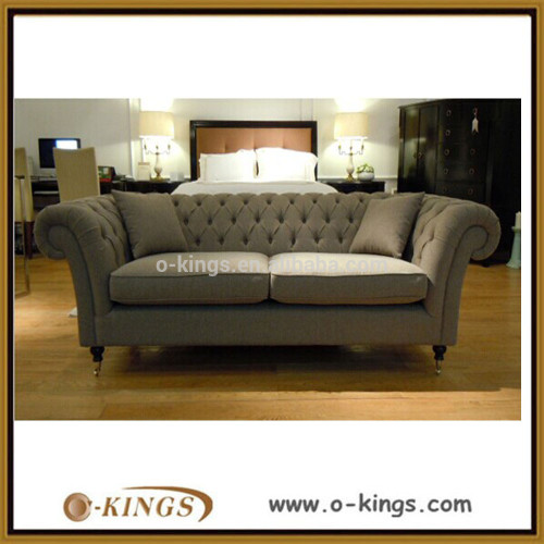 light gray fabric chesterfield sofa with two pillows