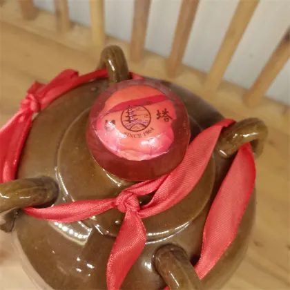 Yellow porcelain jar filled with yellow wine