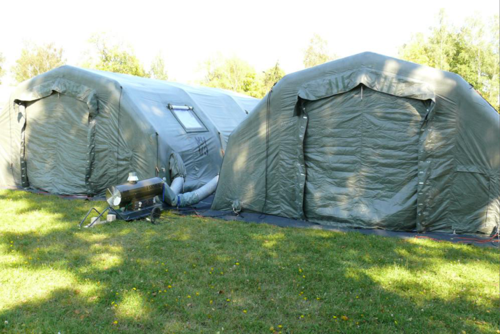 Military green inflatable camping tents in the field