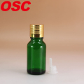 Bottiglia di vetro di olio essenziale verde con riduttore e tappo di orifizio