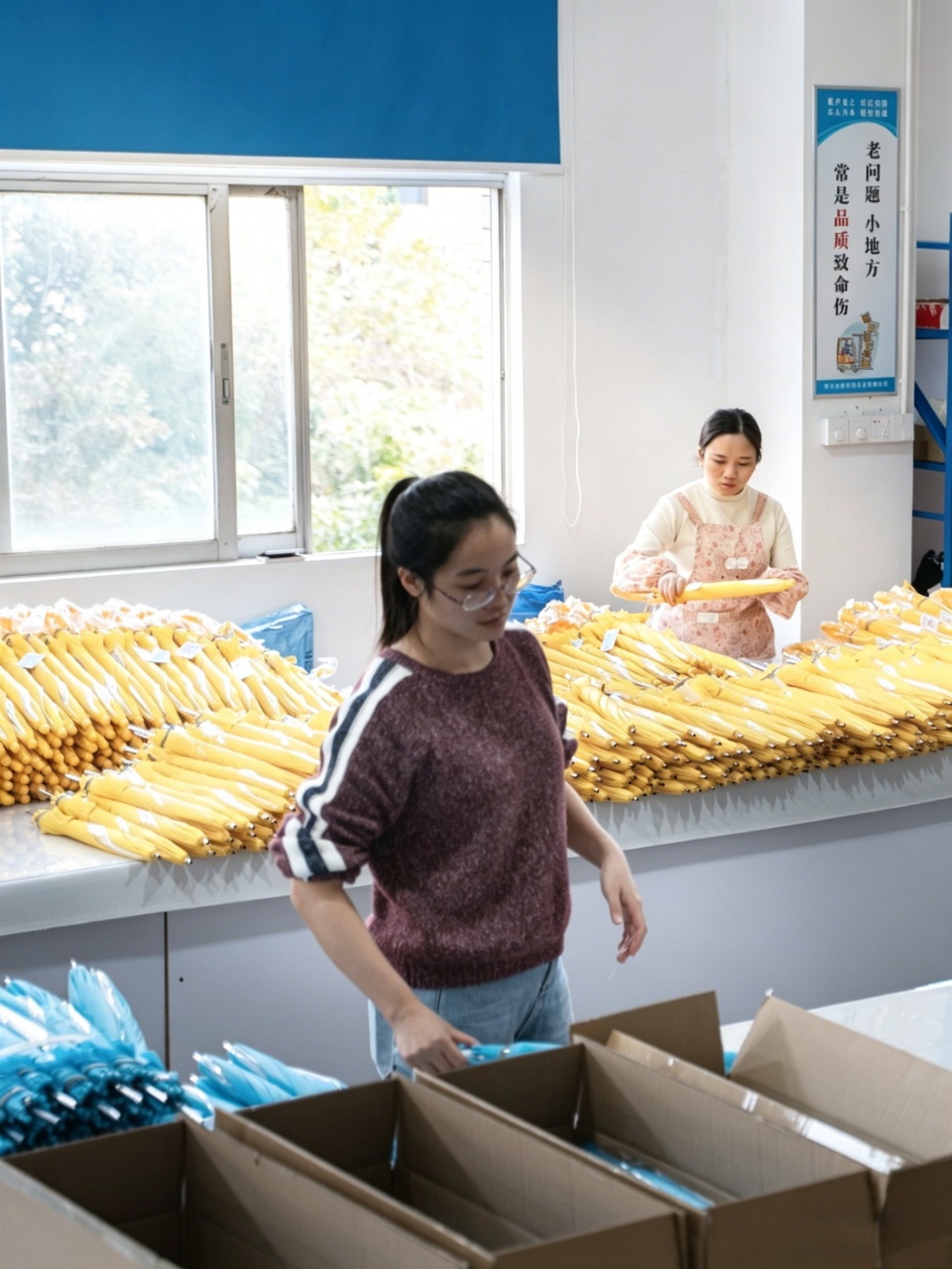 Worker-packaging-umbrella-into-carton-for-shipping