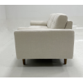 Light colored fabric three person sofa