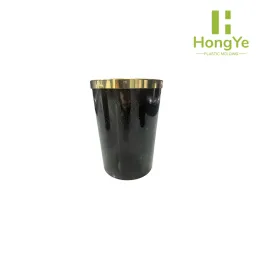 Large plastic black with gold dots trash can