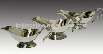 shiny stainless steel gravy boat with holder