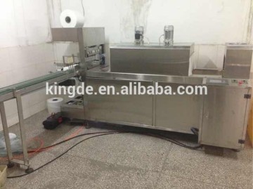Fully automatic shrink wrapper machine