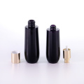 Black glass bottle with golden aluminum cap